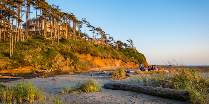 The sun shining upon the Seabrook bluff as it sets into the Pacific Ocean