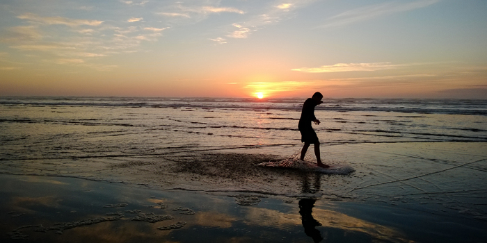 Skim boarding as the sun goes down